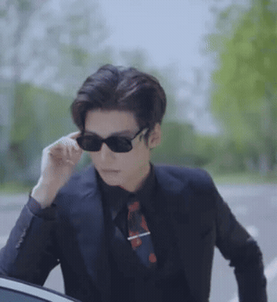 Man In Sunglasses And Suit Next To Car GIF