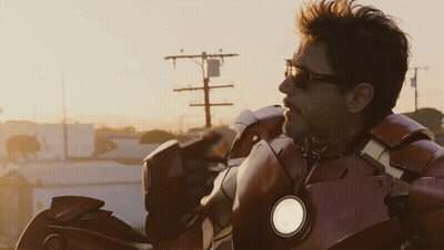 Man In Sunglasses And Superhero Suit Looking To Side GIF