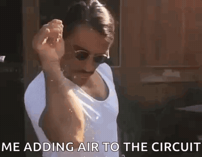 Man In Sunglasses And Tank Top Adding Air To Circuit GIF