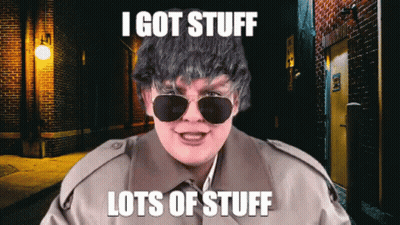 Man In Sunglasses And Trench Coat Saying I Got Stuff Lots Of Stuff GIF