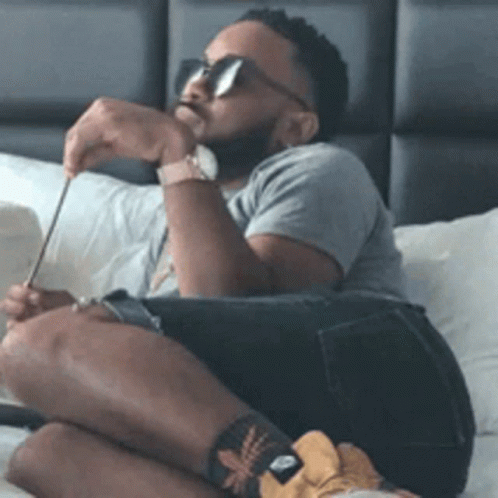 Man In Sunglasses And Watch Sitting On Bed GIF