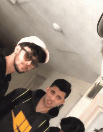 Man In Sunglasses And White Hat Next To Man In Black Hoodie GIF