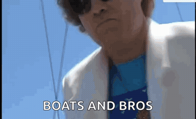 Man In Sunglasses And White Jacket On A Boat GIF