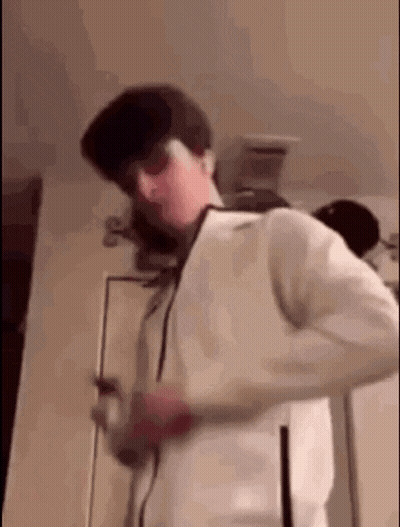 Man In Sunglasses And White Jacket Standing By Door GIF