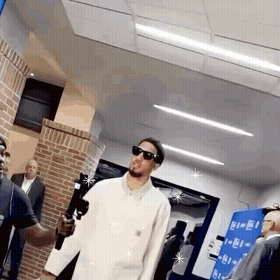 Man In Sunglasses And White Shirt Holding Microphone GIF