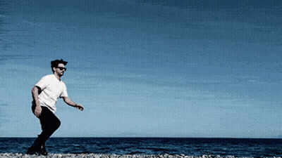 Man In Sunglasses And White Shirt On Beach GIF