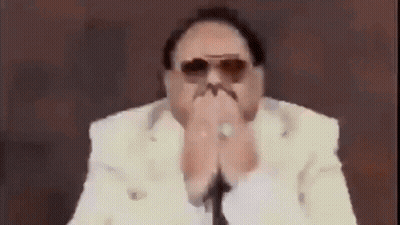 Man In Sunglasses And White Suit Covering Mouth GIF