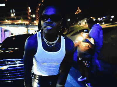 Man In Sunglasses And White Tank Top Standing By Car GIF