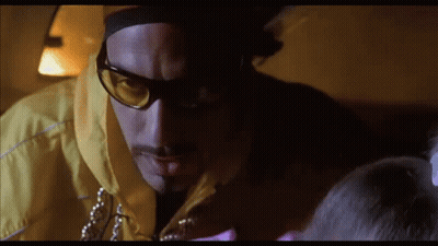 Man In Sunglasses And Yellow Jacket Looking Down GIF