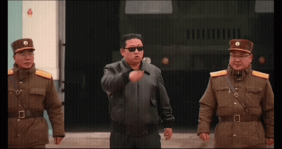 Man in Sunglasses Between Two Uniformed Men