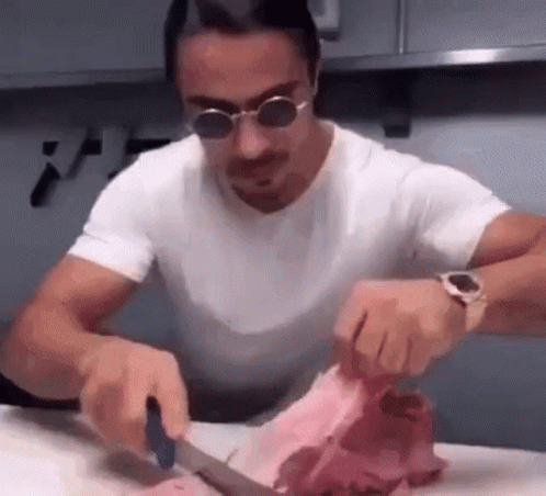 Man In Sunglasses Cutting Meat GIF