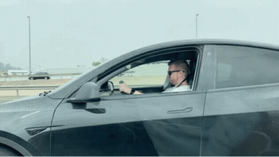 Man In Sunglasses Driving Tesla Model Y GIF