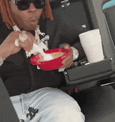 Man In Sunglasses Eating In Car GIF