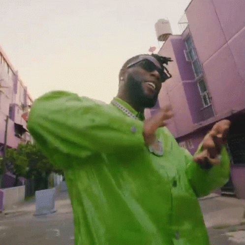 Man In Sunglasses, Green Shirt, Purple Building GIF