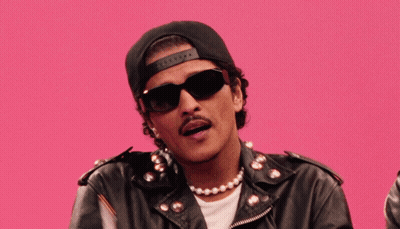 Man In Sunglasses Hat And Leather Jacket Holding Two Flags GIF