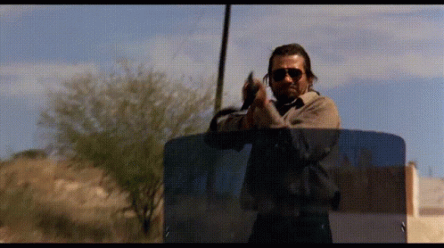 Man In Sunglasses Holding Gun GIF