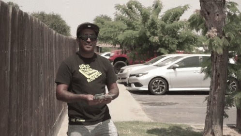 Man In Sunglasses Holding Gun GIF