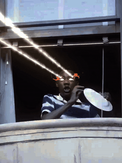 Man In Sunglasses Holding Plate In Front Of Eyes GIF