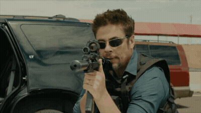 Man In Sunglasses Holding Rifle By Car With LT GIF