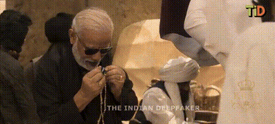 Man In Sunglasses Holding Rosary In Front Of TD Screen GIF