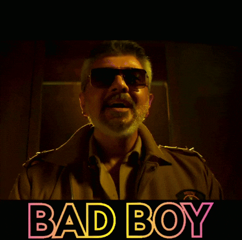 Man In Sunglasses In Front Of Bad Boy Sign GIF