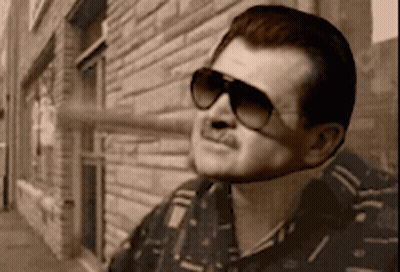 Man In Sunglasses In Front Of Brick Building GIF