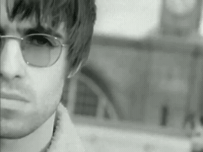 Man In Sunglasses In Front Of Clock Tower Black And White GIF
