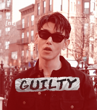 Man In Sunglasses In Front Of Guilty Sign GIF