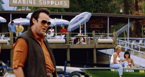 Man In Sunglasses In Front Of Marine Supplies Sign GIF