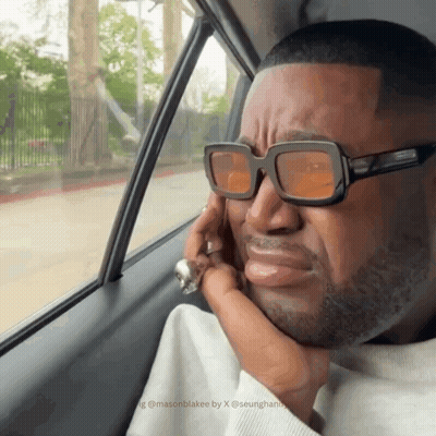 Man In Sunglasses Looking Out Car Window GIF