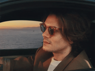 Man In Sunglasses Looking Out Car Window GIF