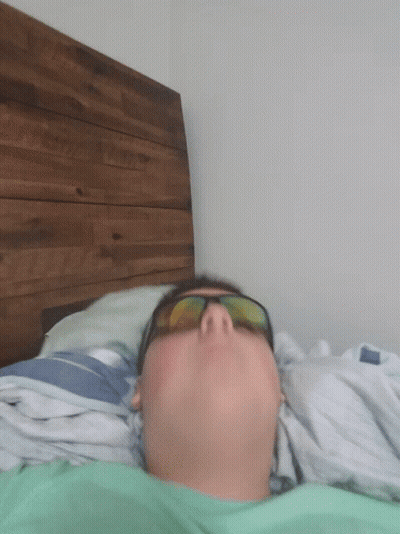 Man In Sunglasses Lying On Bed Eyes Closed GIF