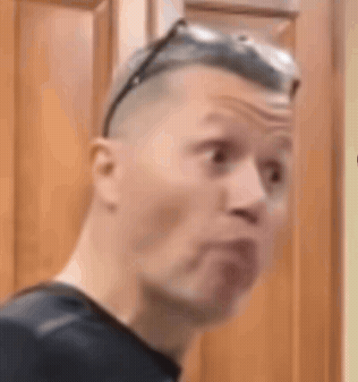 Man In Sunglasses Making Funny Face In Front Of Wooden Cabinet GIF
