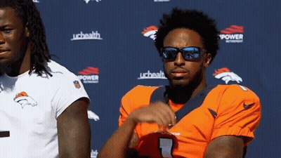 Man In Sunglasses Next To Man In Broncos Jersey GIF