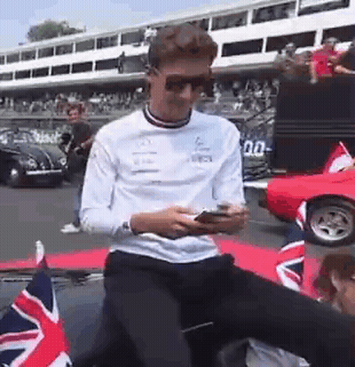 Man In Sunglasses On Car Looking At Phone GIF