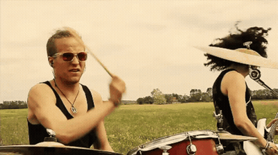 Man In Sunglasses Playing Drums With Woman GIF