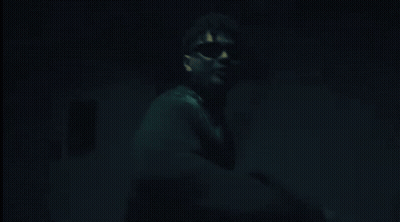 Man In Sunglasses Pointing In Dark GIF