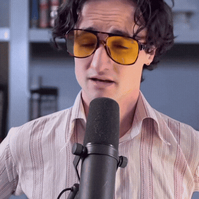 Man In Sunglasses Singing Into Microphone With Eyes Closed GIF