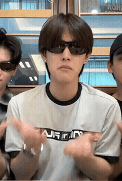 Man In Sunglasses Sitting At Table Hands In Air GIF