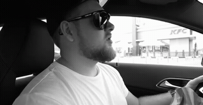 Man In Sunglasses Sitting In Car In Front Of KFC GIF
