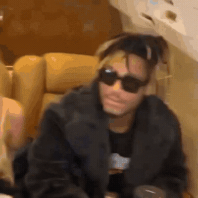 Man In Sunglasses Sitting On Couch GIF