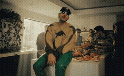 Man In Sunglasses Sitting On Counter With Food GIF