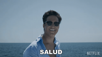 Man In Sunglasses Smiling At Ocean With Salud GIF