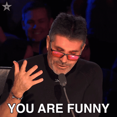 Man In Sunglasses Speaking Into Microphone Saying You Are Funny GIF
