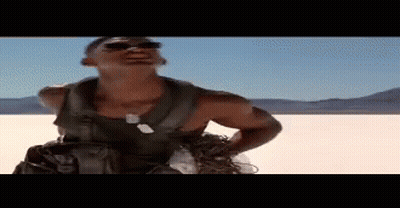Man In Sunglasses Standing In Desert Hands On Hips GIF