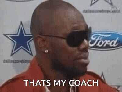Man In Sunglasses Standing In Front Of Ford Logo GIF