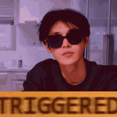 Man In Sunglasses Standing In Front Of Yellow Triggered Sign GIF