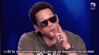 Man In Sunglasses Talking Into Microphone Says Si Tu Recommences GIF