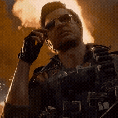 Man In Sunglasses Talking On Cell Phone In Front Of Fire GIF