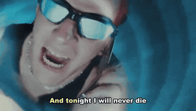Man In Sunglasses Talking On Cell Phone Saying And Tonight I Will Never Die GIF